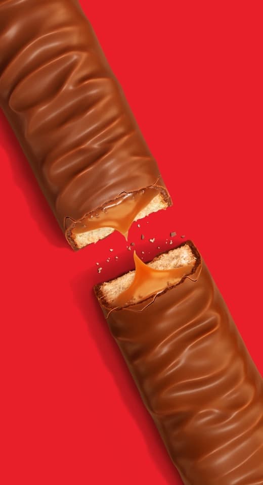 A Twix bar snapped in two on a red background